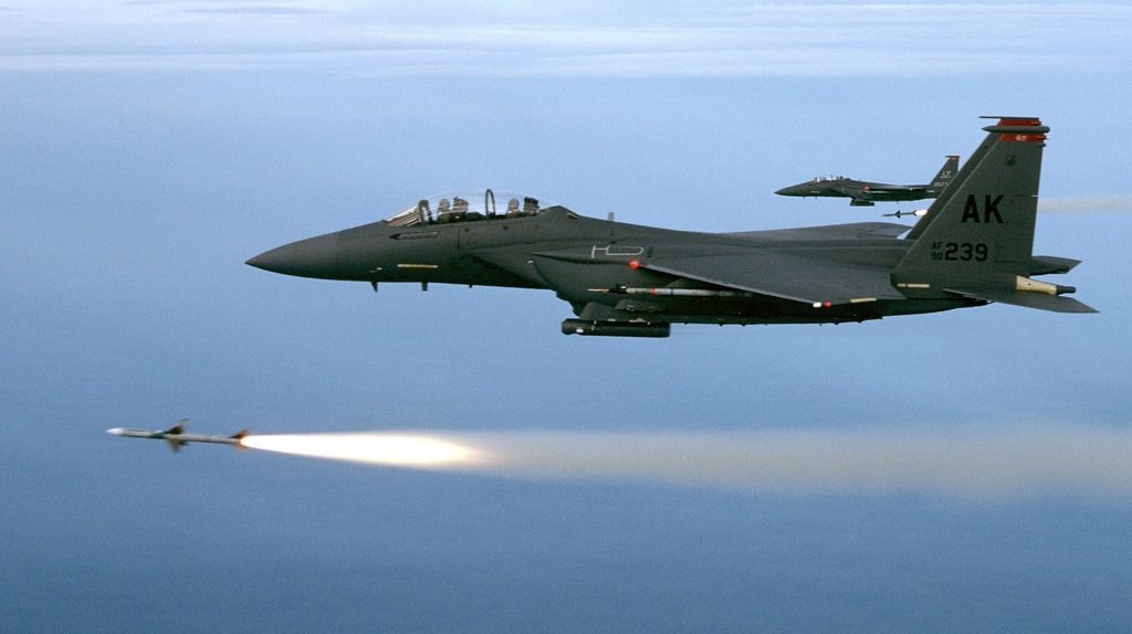 A U.S. Air Force F-15E Strike Eagle releasing a large-diameter guided bomb during a combat operation.