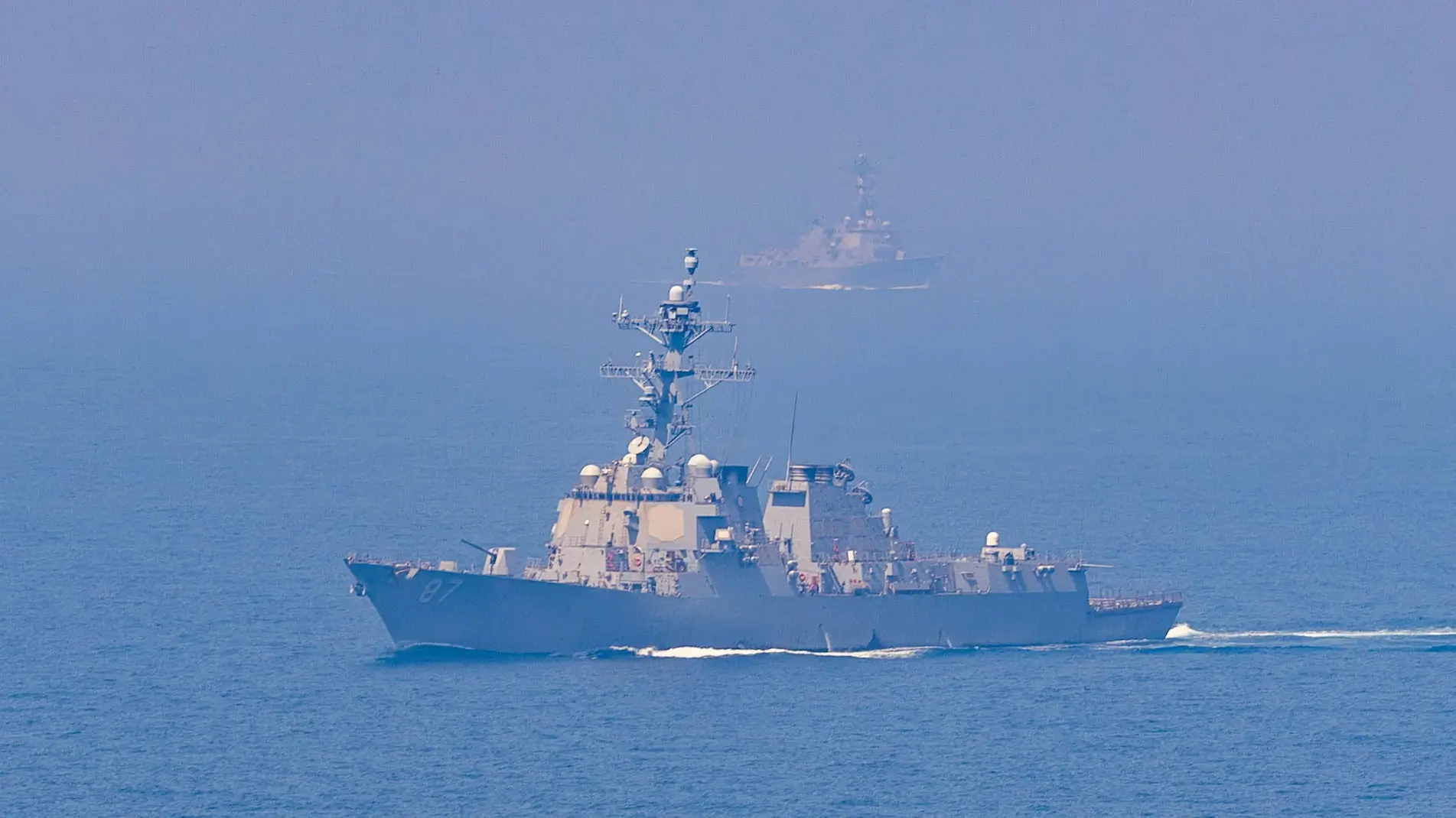 A U.S. Navy guided-missile destroyer transits the Strait of Hormuz, maintaining maritime domain awareness.