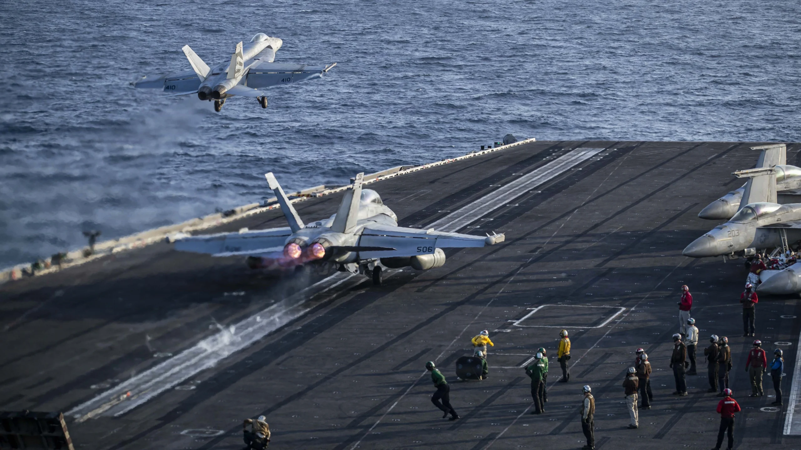 An F/A-18E Super Hornet, attached to Strike Fighter Squadron (VFA) 151, and an EA-18G Growler, attached to Electronic Attack Squadron (VAQ) 133, launch from the flight deck of Nimitz-class aircraft carrier USS Abraham Lincoln (CVN 72)