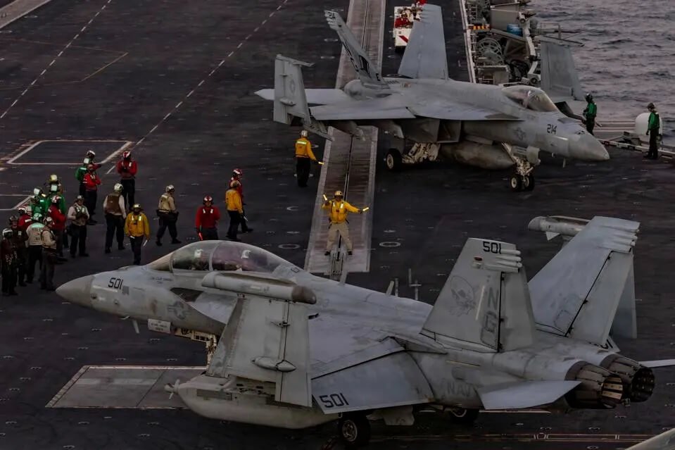Sailors direct an EA-18G Growler, attached to Electronic Attack Squadron (VAQ) 133, on the flight deck of USS Abraham Lincoln (CVN 72) in the Arabian Sea.