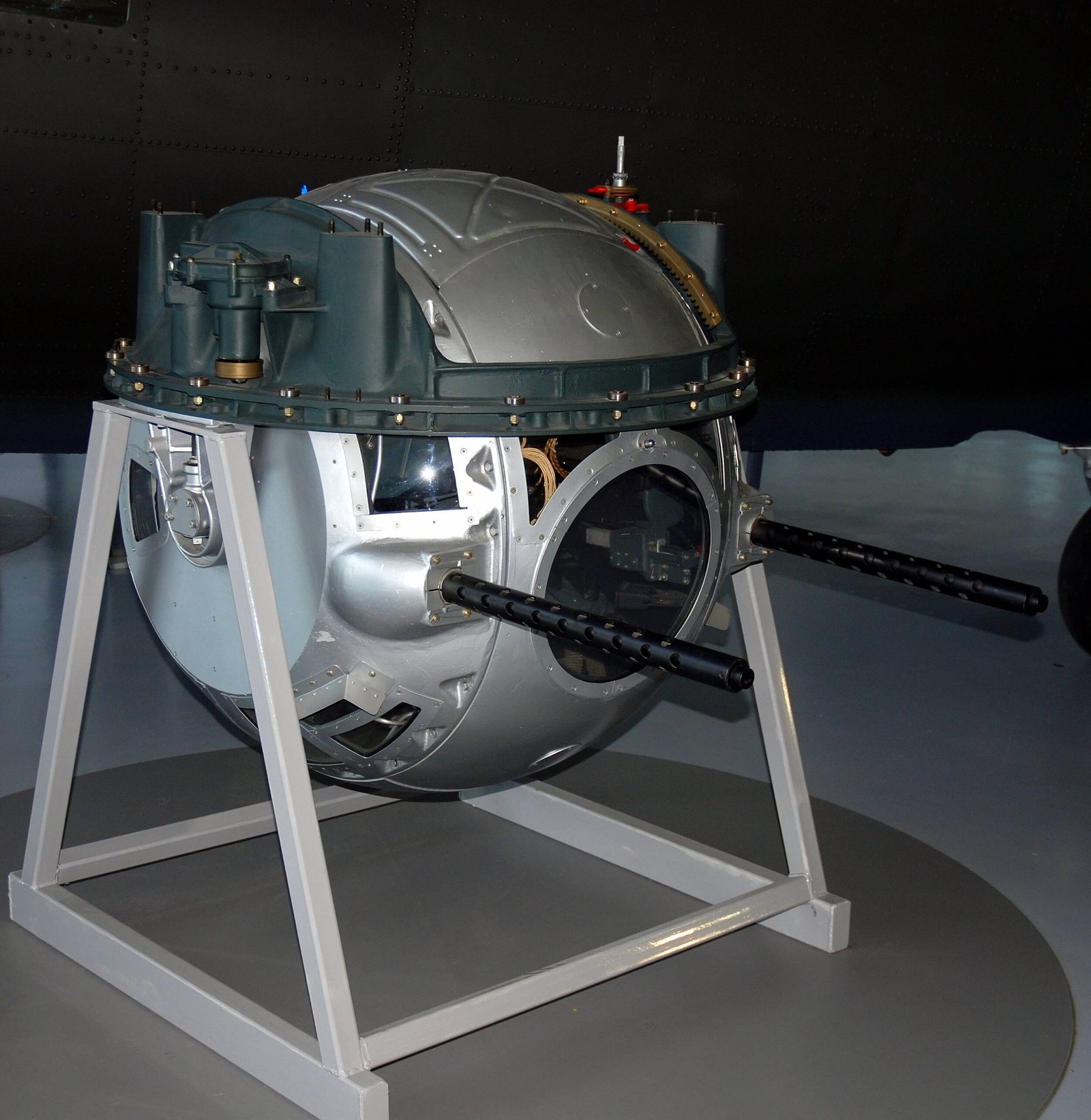 Cutaway diagram or close-up profile of a B-17 ball turret showing the fetal position of the gunner.