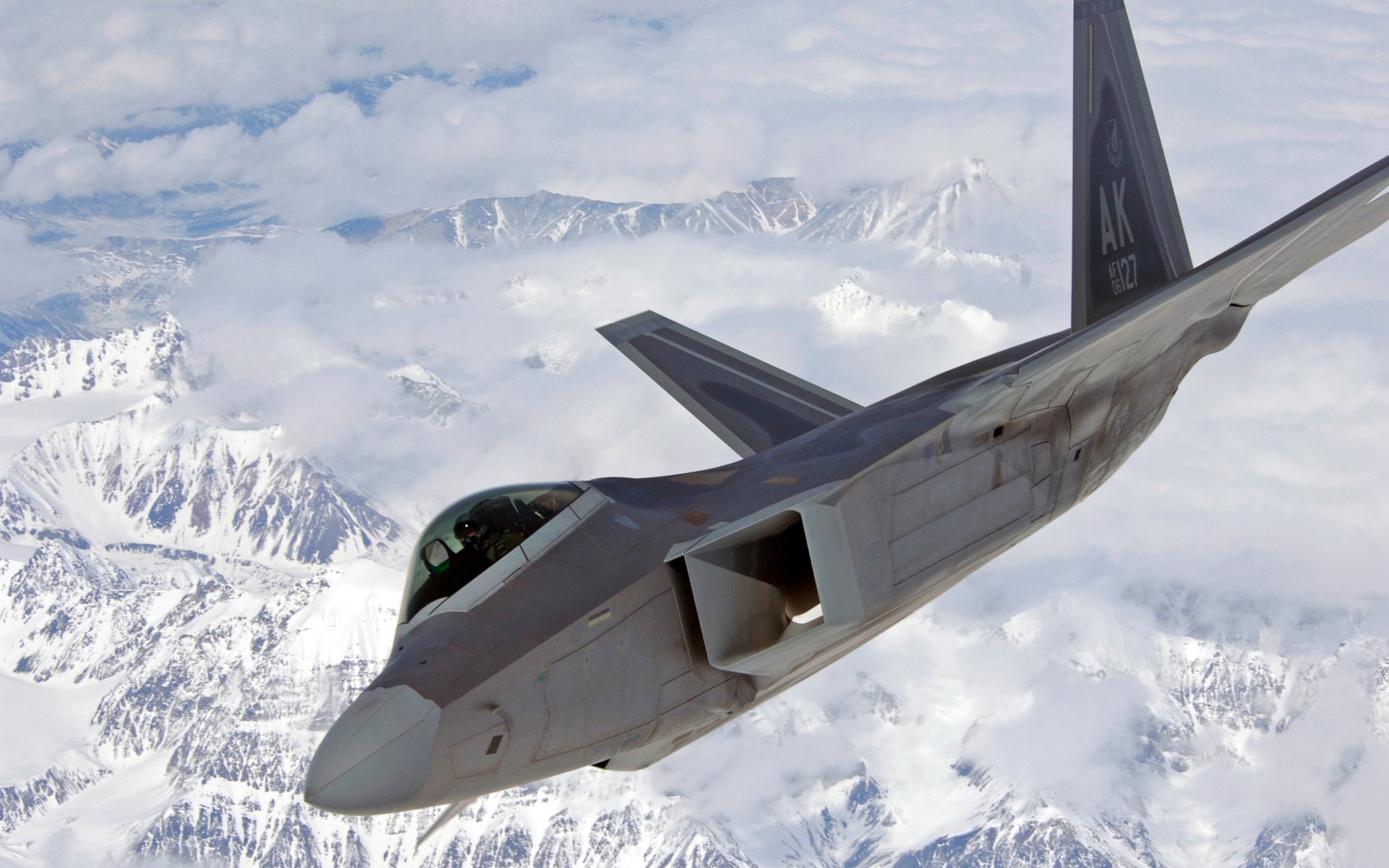 An F-22, based at Elmendorf AFB, Alaska, over mountain terrain