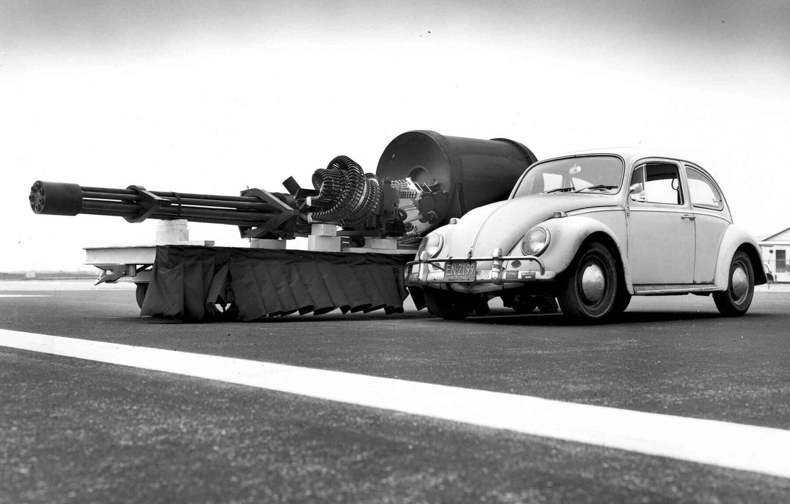 The GAU-8/A Avenger Gatling gun next to a Volkswagen Beetle. Removing an installed GAU-8 from an A-10 requires first installing a jack under the aircraft's tail to prevent it from tipping, as the cannon makes up most of the aircraft's forward weight.