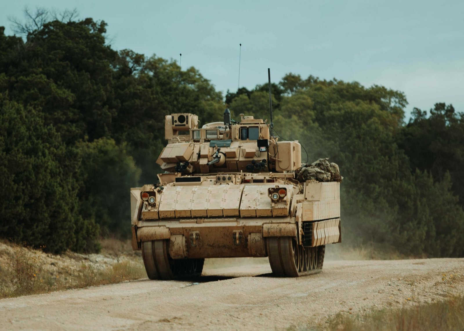 A U.S. Army M2A4 Bradley infantry fighting vehicle maneuvering on rugged terrain during testing exercises.