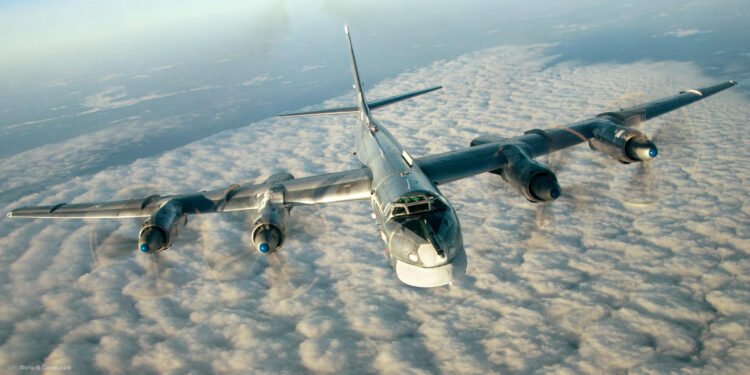 A Russian Tu-95 strategic bomber in flight, showcasing its swept wings and four turboprop engines.