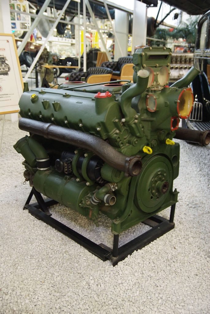 an image of King Tiger German Tank Engine. The 23-liter V-12 Maybach HL 230 P30 cast-iron gasoline engine delivering 700 horsepower at 3,000 rpm and 1,364.5 lb-ft of torque at 2,100 rpm.