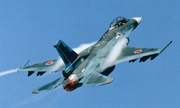 A Japanese F-2 fighter jet equipped with a large supersonic ASM-3 missile on the wing pylon.