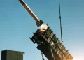 MIM-104 Patriot surface-to-air missile system launching an interceptor at night against an incoming ballistic target.