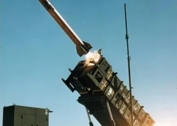 MIM-104 Patriot surface-to-air missile system launching an interceptor at night against an incoming ballistic target.