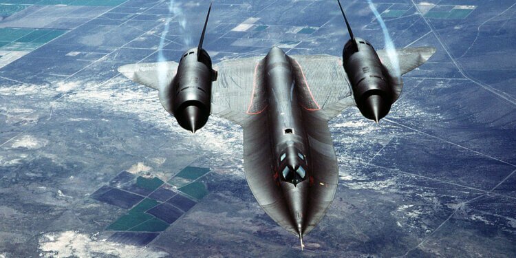 An air-to-air overhead front view of an SR-71A strategic reconnaissance aircraft. The SR-71 is unofficially known as the "Blackbird."
