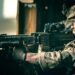 A U.S. Army 75th Ranger armed with a KAC LAMG having an ELCAN Specter prism sight at the upper receiver's picatinny rail.